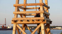 timber observation tower reinterprets kola bay’s industrial shoreline in russia