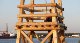 timber observation tower reinterprets kola bay’s industrial shoreline in russia